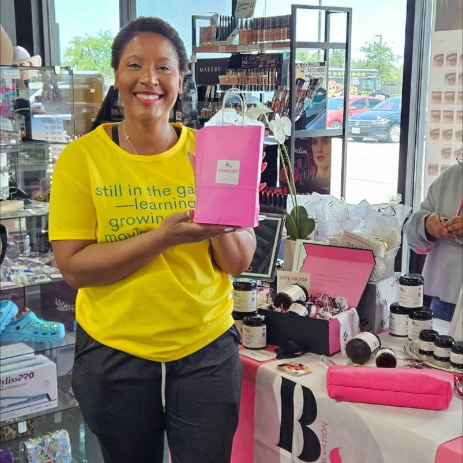 Customer holding a by Aβamia purchase inside A&E Beauty Supply.