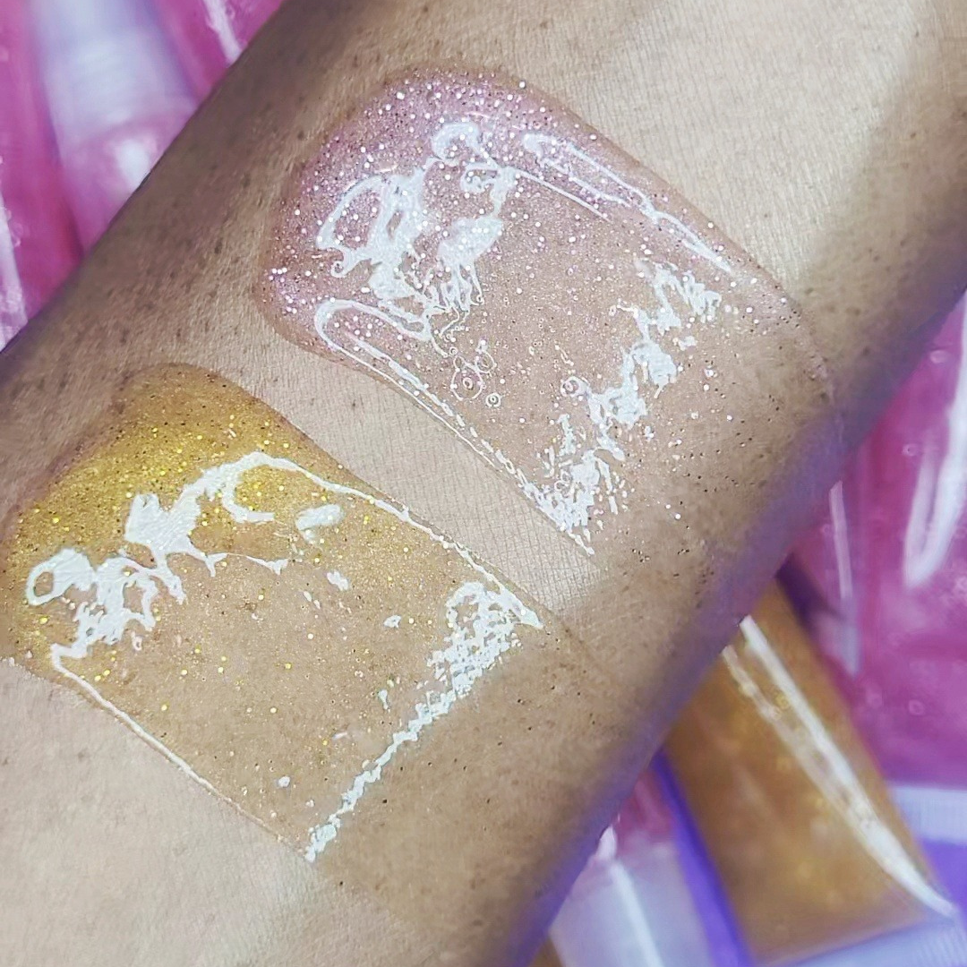 Bubble Gum Glow and 24K Glitter gloss displayed on arm