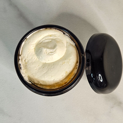 Open 6-ounce jar of by A’amia Eczema Butter showing the rich, substantial body butter texture.