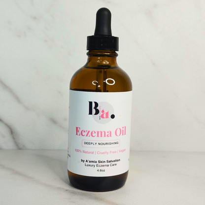by A’amia Eczema Oil in its amber dropper bottle, a lightweight fragrance-free moisture layer for sensitive skin.