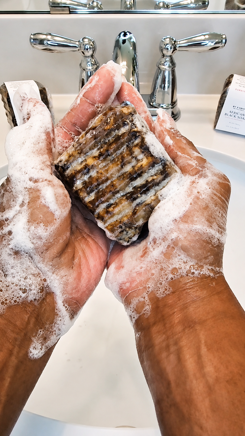 by A’amia African Black Soap worked into a creamy lather in wet hands before cleansing.