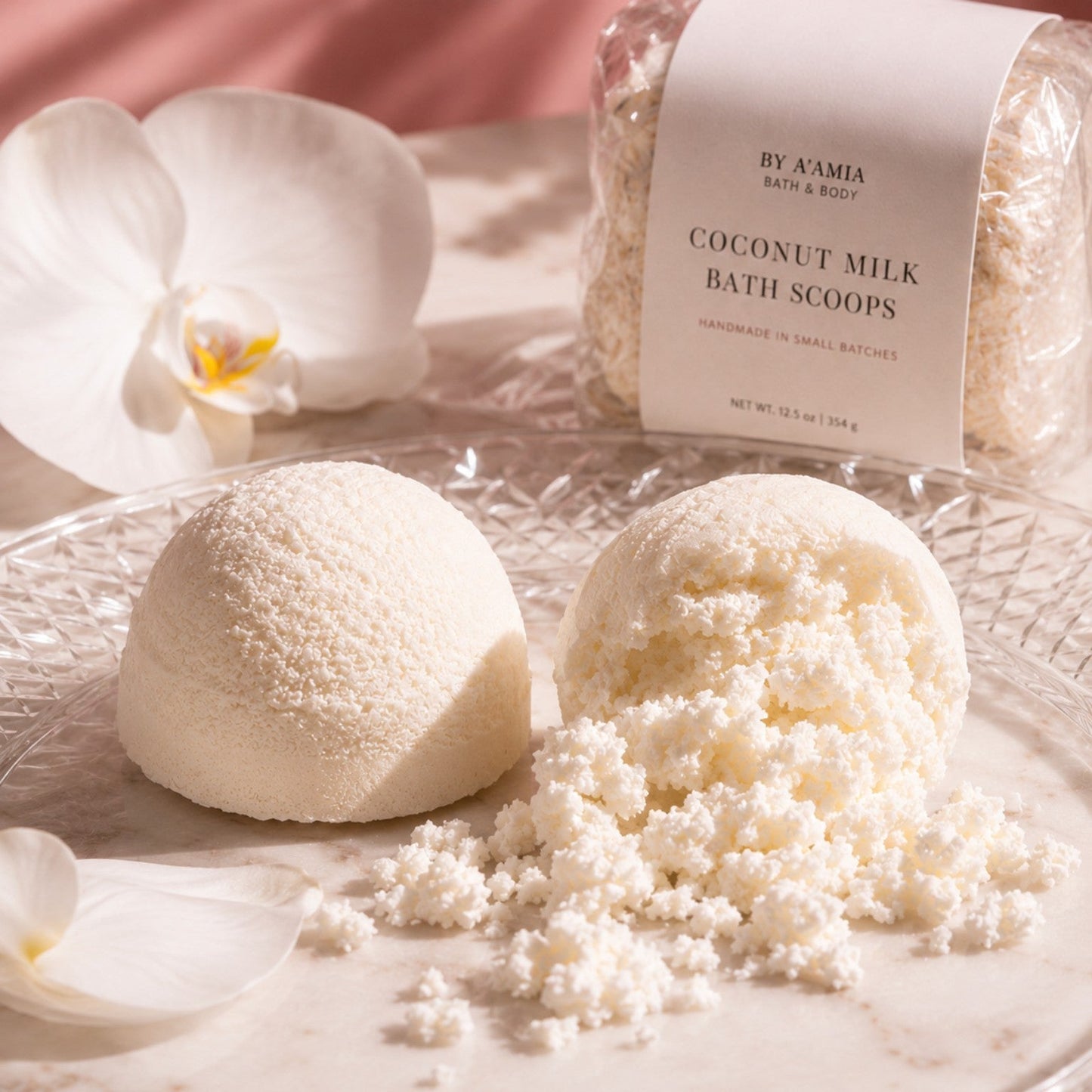 by A’amia Coconut Milk Bath Scoops shown with the packaged product and two creamy handmade scoops, including one crumbled to reveal the fragrance-free bath soak texture.
