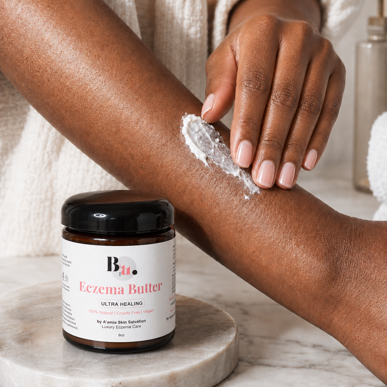 A Black woman applies by A’amia Eczema Butter to her forearm, showing the rich all-over moisture layer on honest skin.